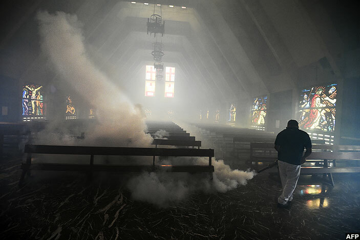   ealth inistry employee fumigates against the edes egypti mosquito inside a church in aracas olombia
