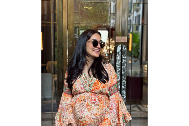 Surbhi Jyoti flaunts her baby bump in a flowy printed dress