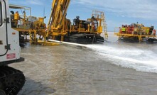 One of Ausdrill's lake walker reverse circulation drills. The white vehicle in the foreground is the personnel carrier