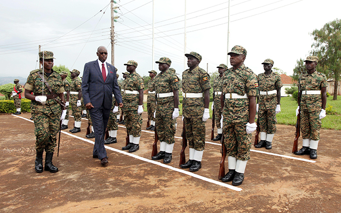 tate minister of defence right wamirama inspecting a military parade during the official opening of the training exercise at the  unior taff ollege in inja hoto by ajarah alwadda