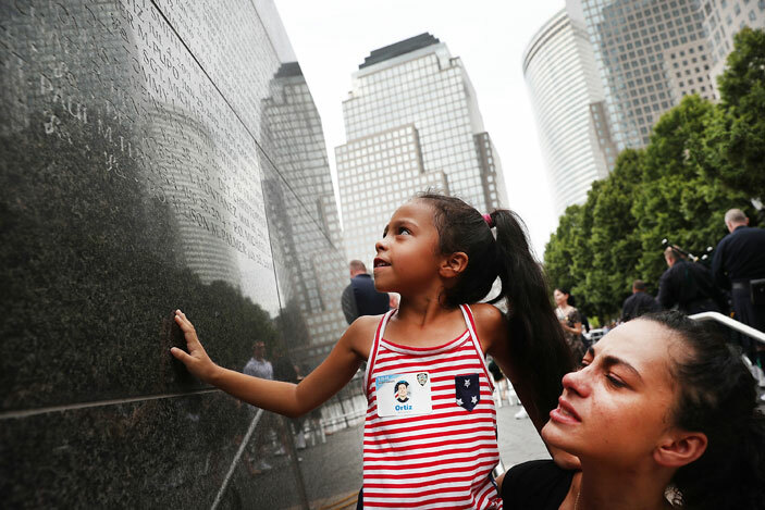 ernadette rtiz holds up her daughter driana as she looks for the name of her grandfather fallen ew ork ity olice officer dwin rtiz at a wall commemorating fallen officers on eptember 9 2016 in ew ork ity   pencer lattetty mages