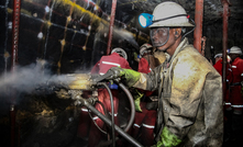  Underground Platinum Chrome miners drilling holes in rock for blasting