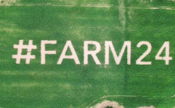 Giant #farm24 logo planted in field of maize 
