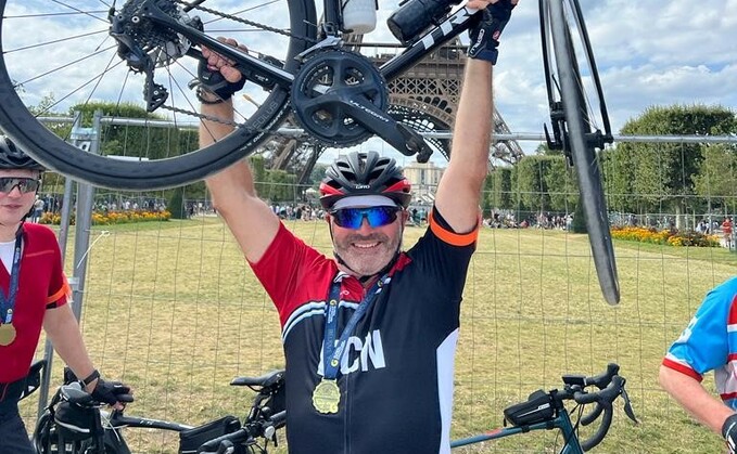 Wiltshire farmer Julian Cooke in front of the Eiffel Tower after completing over 300 miles on a bike ride from London to Paris for a farming mental health charity (Farming Community Network)