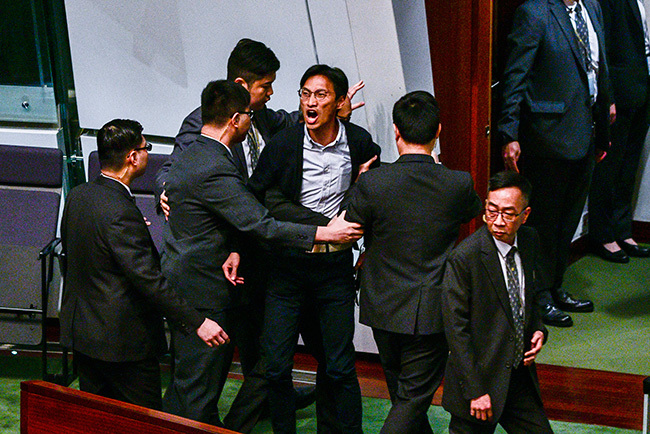   rodemocracy lawmaker ddie hu  yells while being removed from the legislative council hoto by     