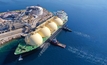 LNG (Liquified Natural Gas) tanker anchored in small gas terminal island with tanks for storage