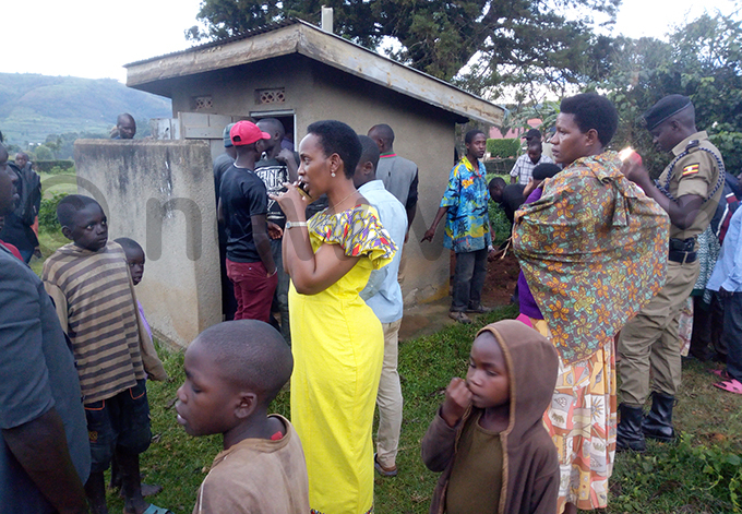 esidents gathered around the latrine where the baby was dumped hoto by ob amanya