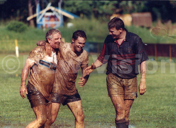 2002 otswana rugby team coach artin olley left walks off with some of his players after testing the muddy yadondo ugby ground ahead of their clash against the ganda rugby side 