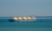 LNG export ship with tugboats in the Timor Sea harbour in Darwin, Australia