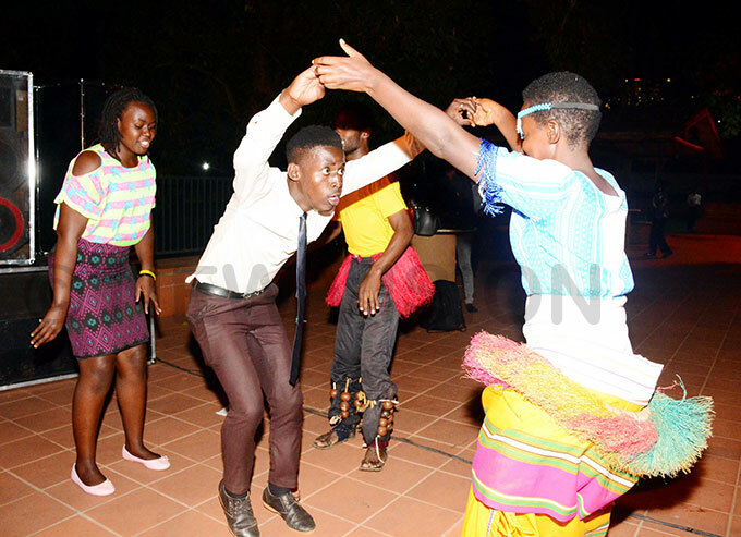   participant challenges a traditional dancer at the ost orld opulation ay dialogue in ampala  hoto by ddie sejjoba
