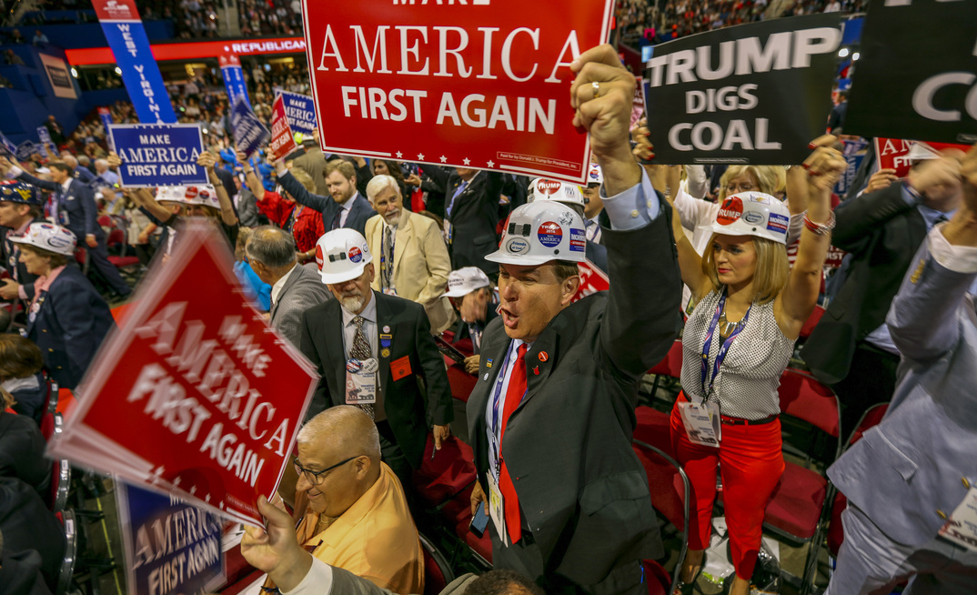 Trump supporters in West Virginia hold up pro-coal sign.