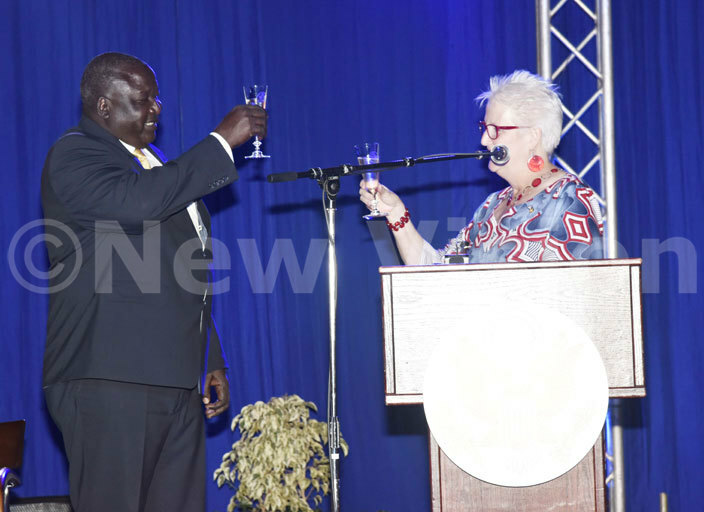  he  ambassador to ganda eborah  alac and the state minister for oreign ffairs enry ryem kello toast during the celebration