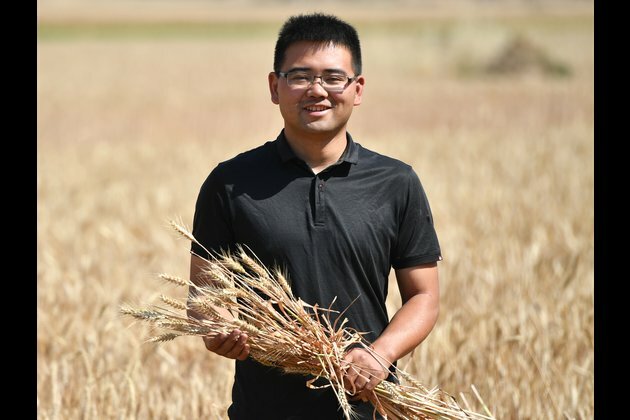 Young man devotes to agricultural machinery works in C China