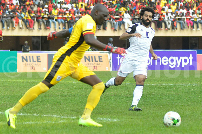 nyango clears the ball under pressure from gypts alah