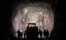  Miners operating a jumbo drill at the face of a high-grade development drift near the centre of the Kakula Mine