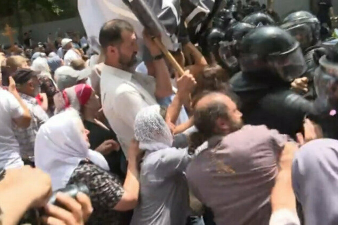 Police knock priest to the ground during anti-LGBT protest 