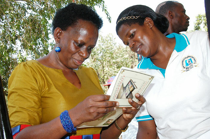  r race ambatya yeyune left being shown a booklet by ydia atovu from pererw