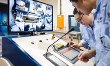  Technicians operating the Chrysos photon assay unit