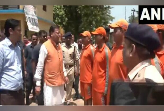 Uttarakhand CM Pushkar Singh Dhami interacts with rescue personnel in flood-affected Khatima