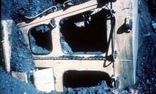 A historical image of a dozer engulfed in coal.