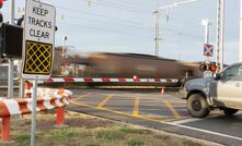 A loaded coal train going through a level crossing in Queensland. Photo: Shutterstock