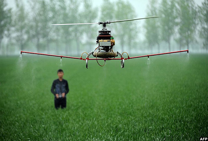   man controlling a drone to spray pesticides on a farm in ozhou central hinas nhui province