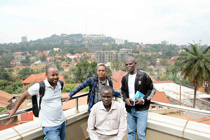  ournalists from the   on  top of a building in tinda hoto by ddie sejoba