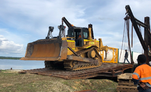  A barge unloads machinery on Woodlark Island.