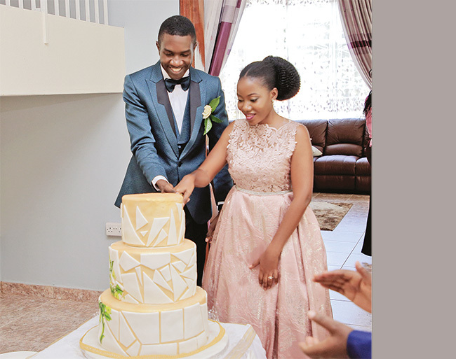  he aziimbas cutting a cake after their wedding lunch at the rchbishops alace in amirembe