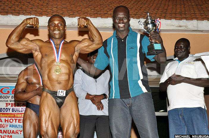  ince wai left who won the ight iddleweight category and was second overall poses before receiving his trophy from ira  mmanuel utukumoi