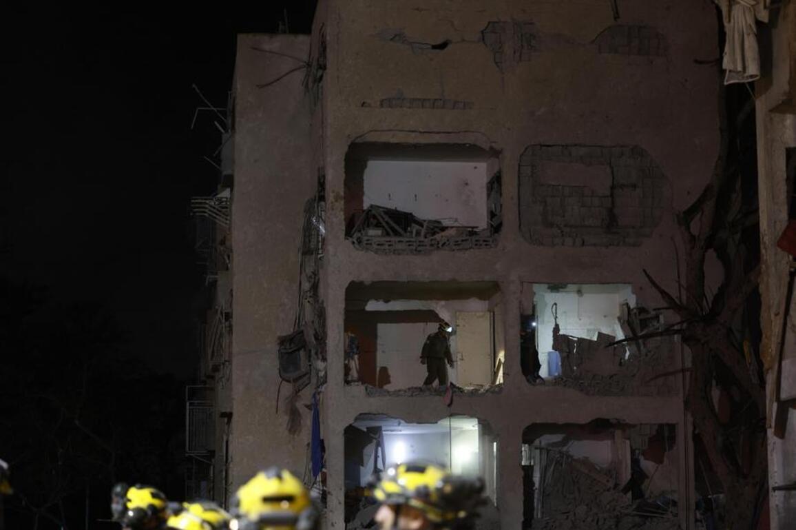 Mideast in Pictures: Iranian missiles wound 200 in southern Israel, testing air defenses