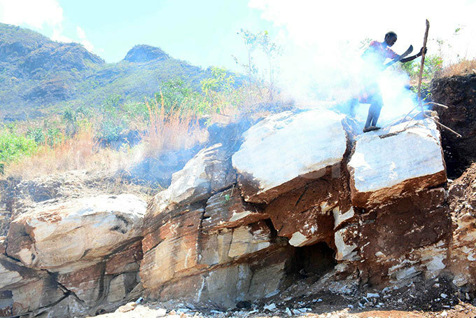   miner making fire around a rock to make it soft