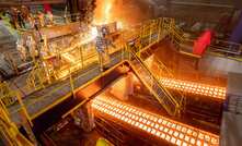 Employees working at the US Steel Gary Works pig iron caster.