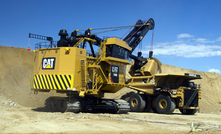 A Cat 7495 electric rope shovel loads a Cat 797F truck in demonstration