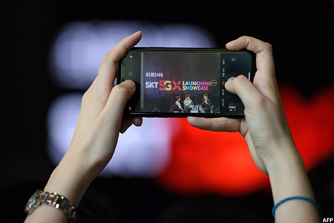  n audience member takes a photo during an  elecom launch event for the companys 5 mobile network in eoul