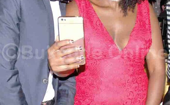 Bano baabadde ku mukolo ogumu mu Kampala nga beekubya ebifaananyi ku ssimu. Bano baabadde ku mukolo ogumu mu Kampala nga beekubya ebifaananyi ku ssimu.