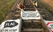  Tammy Omodei and Andy Paine used steel pipes to lock themselves on to the railway carrying the coal from Carmichael.