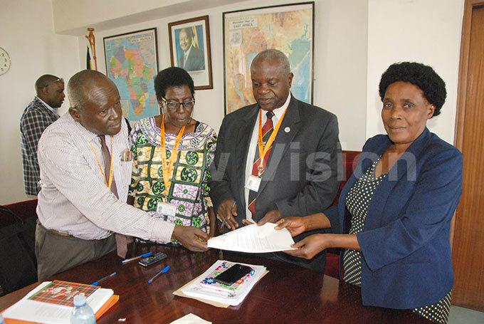  rom left to right  ouncil members of elder persons harles sabirye ehema lupot hairman elder persons oram ibasiimwa handing over the petition to deputy assistant commissioner  eatrice aggy during  the meeting of  ational ouncil for lder ersons at inistry of ender  abour and ocial evelopment 