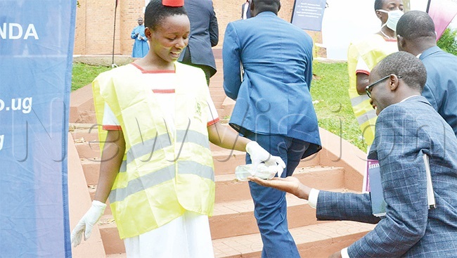  health official sanitising hands of guests who attended the consecration of rchbishop tephen aziimba at amirembe athedral early this year year 19 has made such personal hygiene practices popular