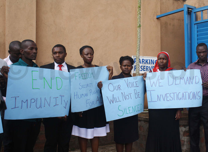 ome of the human rights advocates show off placards protesting the spate of breakins at their offices hoto by eddie usisi