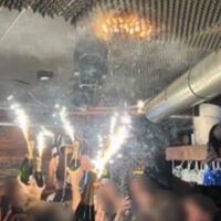 Sparkling candles placed on wine bottles set off fire at Swiss bar