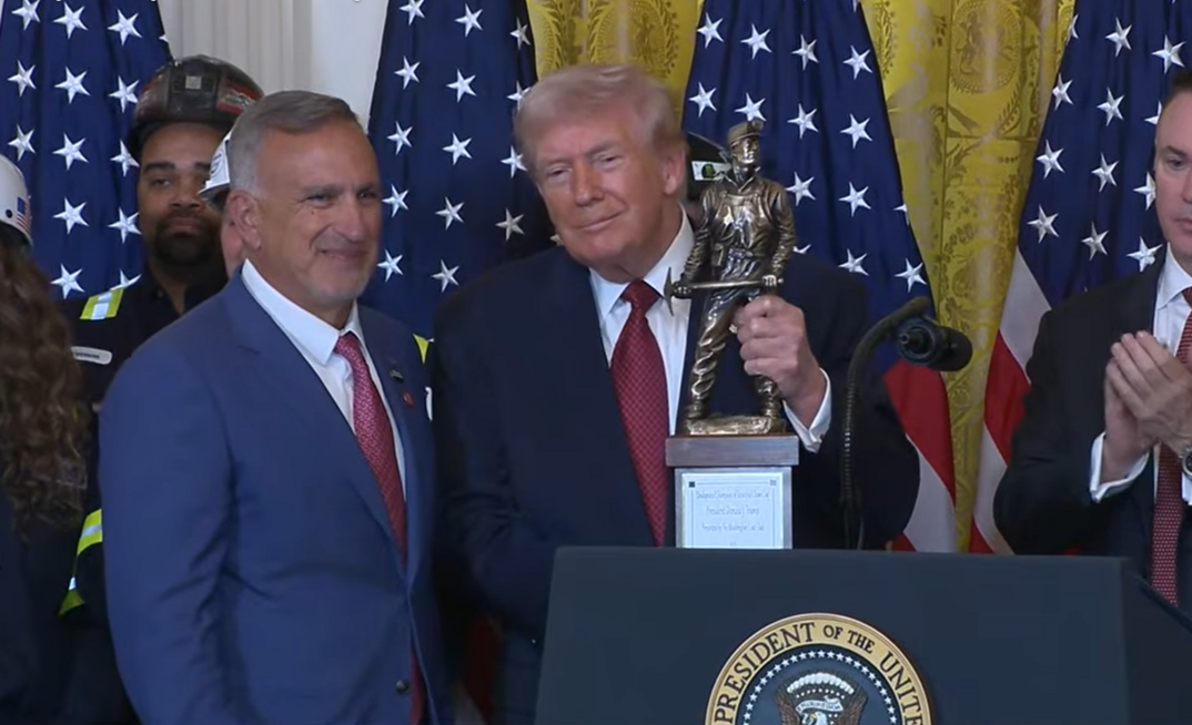 Peabody Energy chief executive Jim Grech hands US president Donald Trump an award for being “the undisputed champion of beautiful clean coal”.