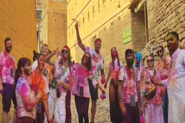 Foreign tourists immerse themselves in the colours of Holi in Jaisalmer