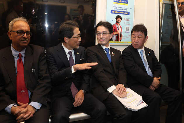 Japanese Foreign Minister Toshimitsu Motegi takes a ride on Delhi Metro