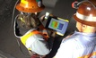 A Barrick network administrator and Rob Kufeld examine data underground on a tablet 
