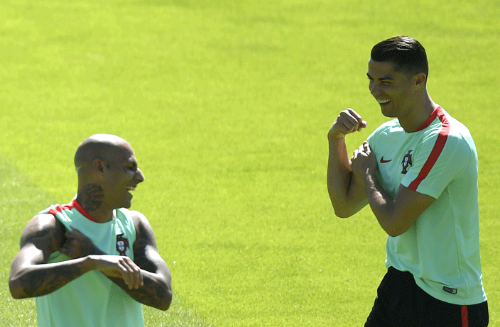  ortugals forward ristiano onaldo  shares a joke with ortugals forward icardo uaresma during a training session at the ortugals base camp in arcoussis