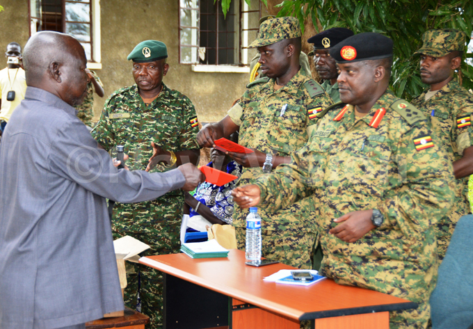   etired t ol receiving his certificate of service from rig anyesigye during the send off event at 4th division barracks in ulu municipality