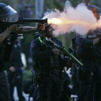 What are the 'less lethal' weapons being used in Los Angeles?