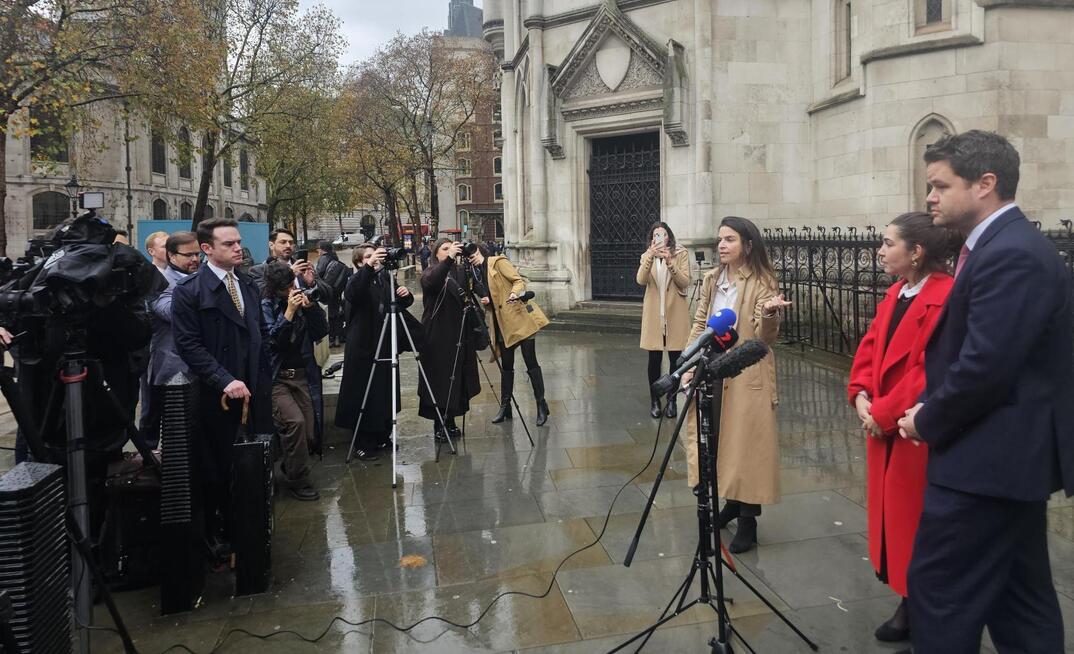 Caroline Narvaz Leite and Tom Ainsworth, from Pogust Goodhead speak outside the High Court, London, today