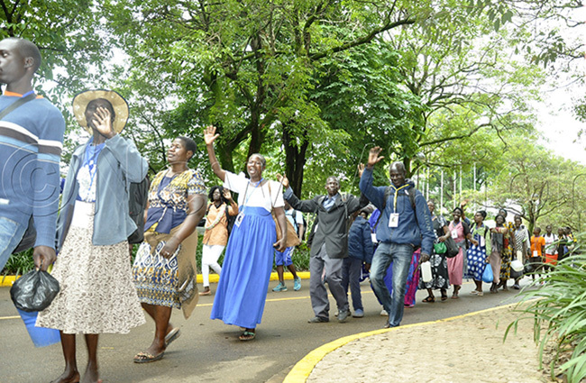  ilgrims waving to people as after commencing the pilgrimage in memory of anan uwum photo by immy uta